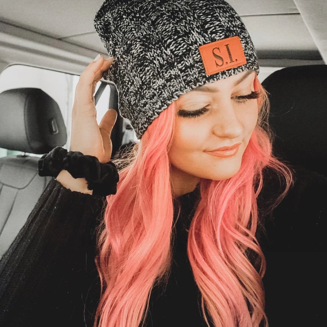 Black and white knit beanie with SI leather tag