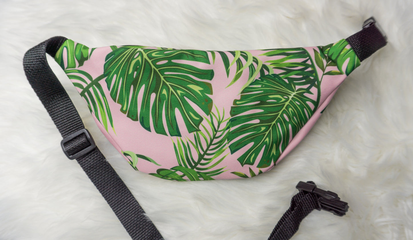 pink fanny pack with green monstera leaves
