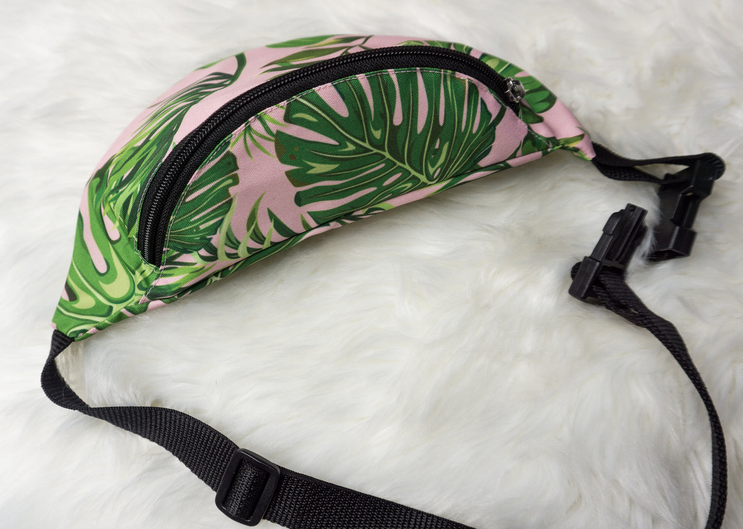 pink fanny pack with green monstera leaves