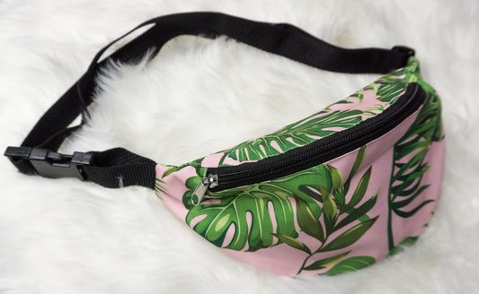 pink fanny pack with green monstera leaves